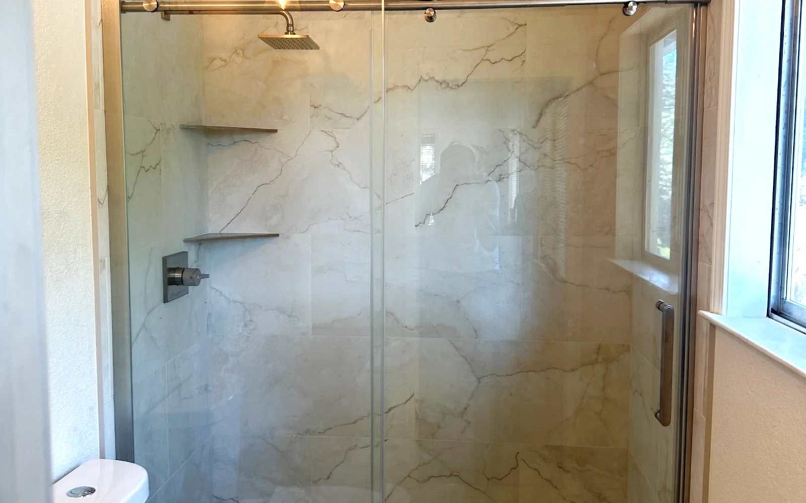 Gold-Framed Tub to Marble-Look Walk-In Shower - Auburn, CA bathroom remodel by Oakwood Remodeling Group