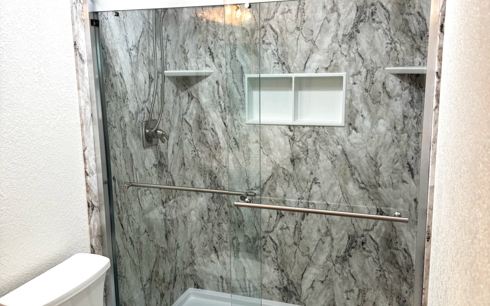 After: Dated Tile Shower to Marble-Look Master Bath - bathroom remodeling Citrus Heights, CA by Oakwood Remodeling Group