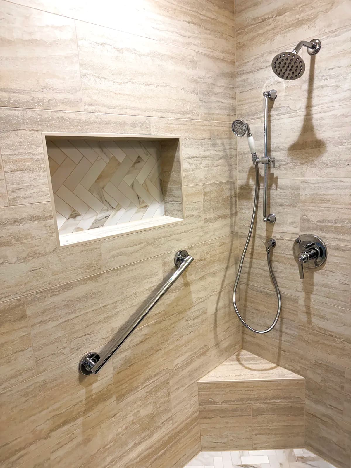 After: two shower heads, recessed marble niche and brushed nickel grab bar