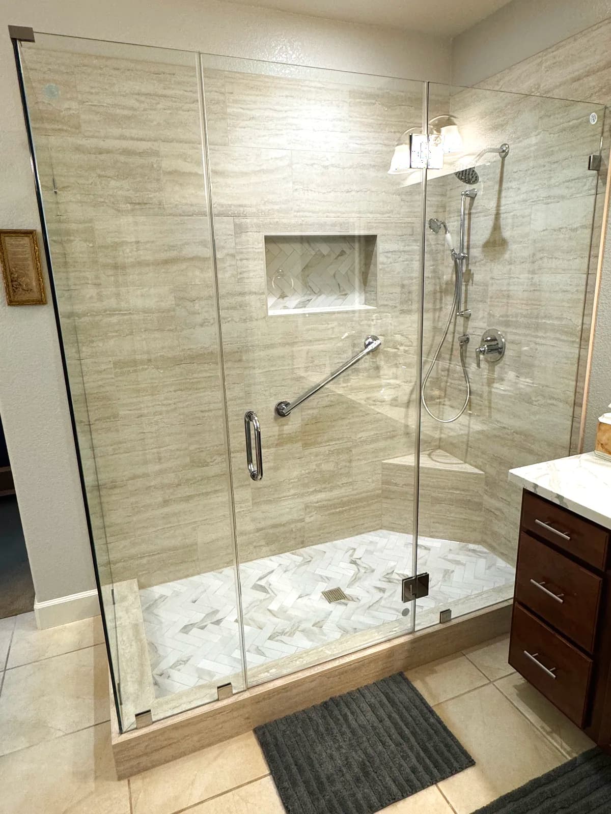 After: frameless glass shower enclosure beside the master vanity