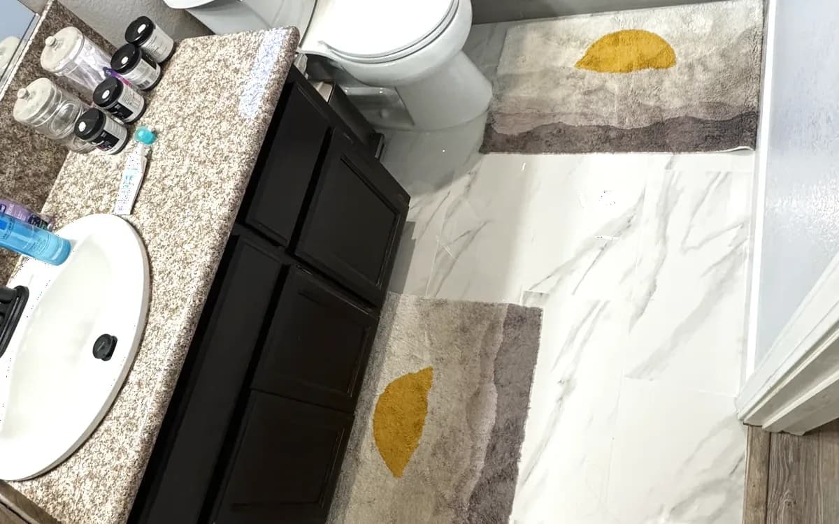 Marble-look porcelain and vanity outside the shower