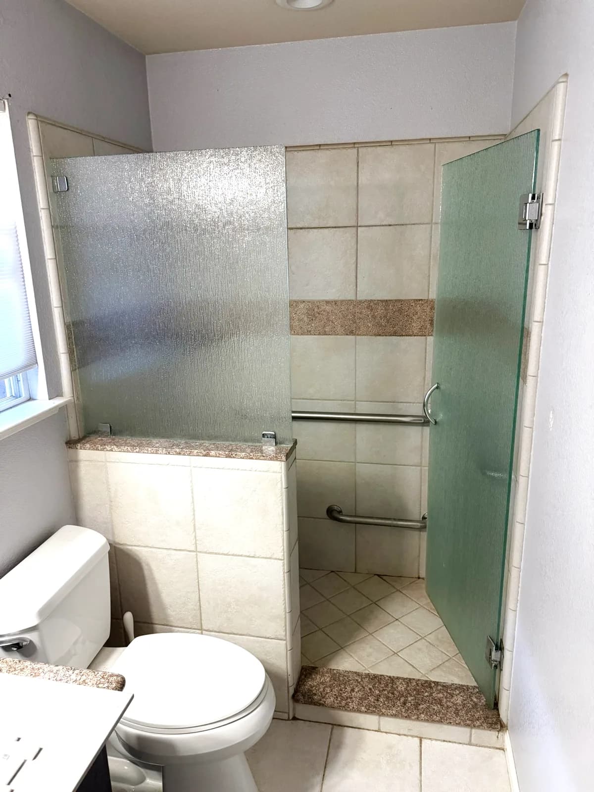 Before: wide view of the old Loomis shower stall and pony wall from the bathroom door