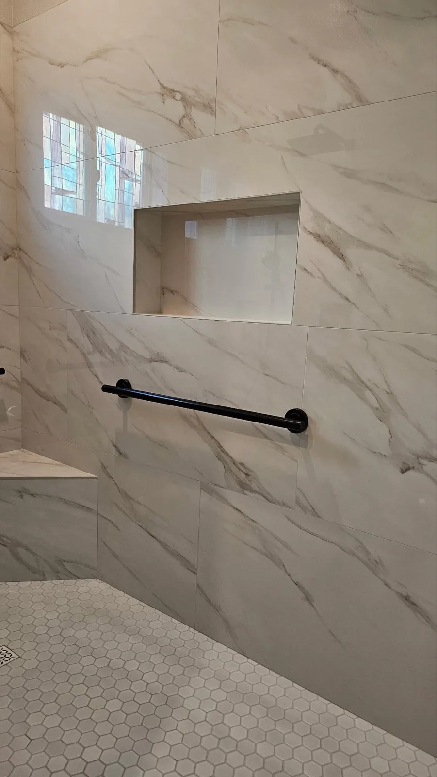 After: Roseville shower second matte black 36-inch grab bar on the side wall beside the bench