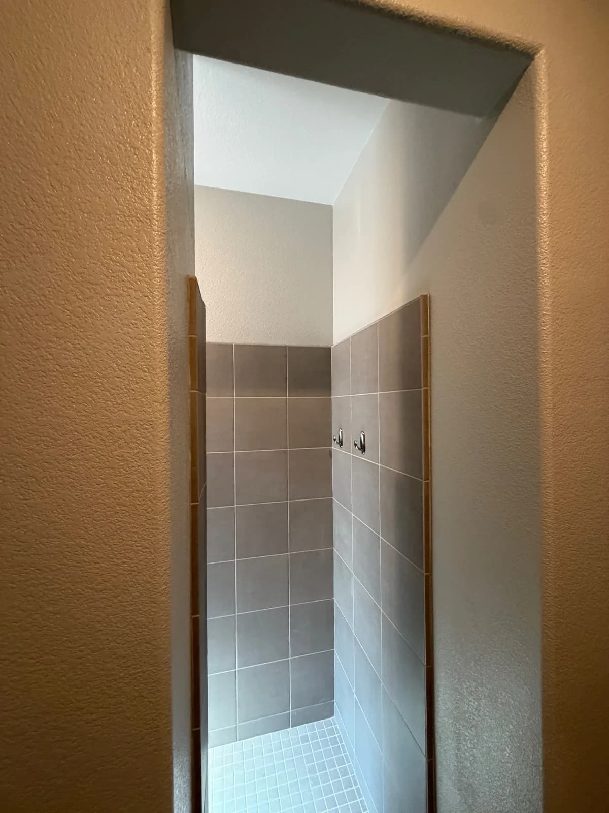 Before: Roseville bathroom showing the narrow doorway into the original shower — barely wide enough for one person