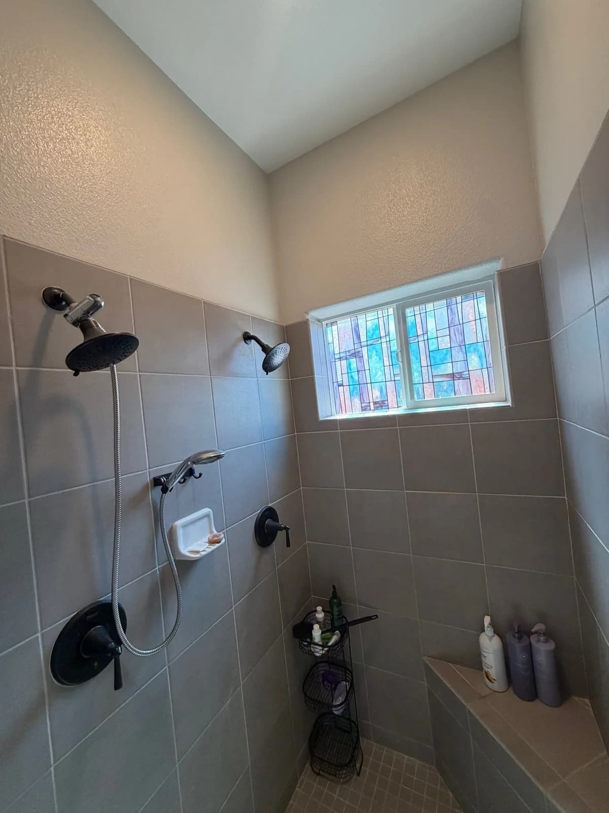 Before: Roseville shower showing existing grey tile walls and original shower curb at floor level