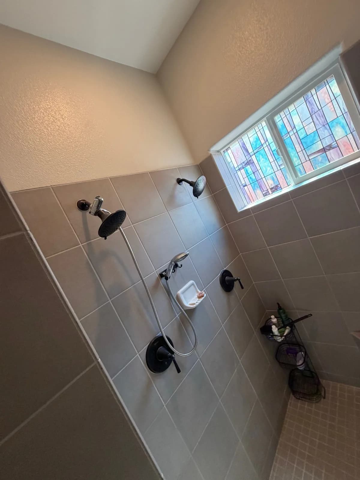 Before: Roseville shower entry detail showing the original narrow framed opening and grey tile beyond