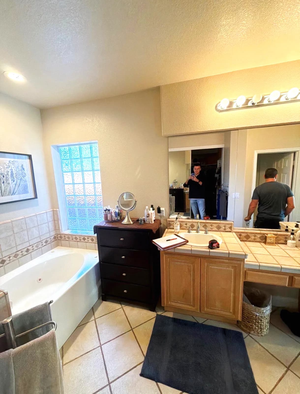 Before: corner drop-in tub next to the double vanity in a Roseville master bathroom
