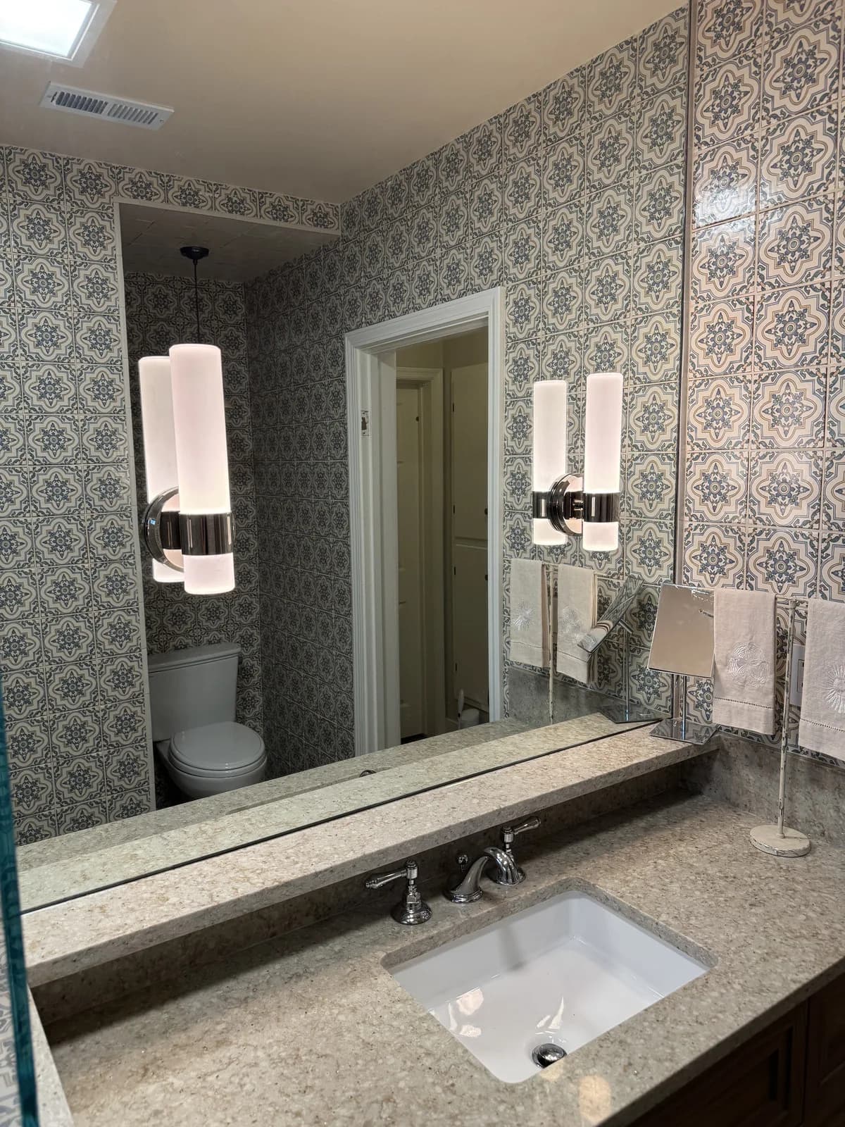 After: Arden bathroom custom dark-wood vanity with stone countertop, undermount sink, chrome faucet and custom frameless mirror