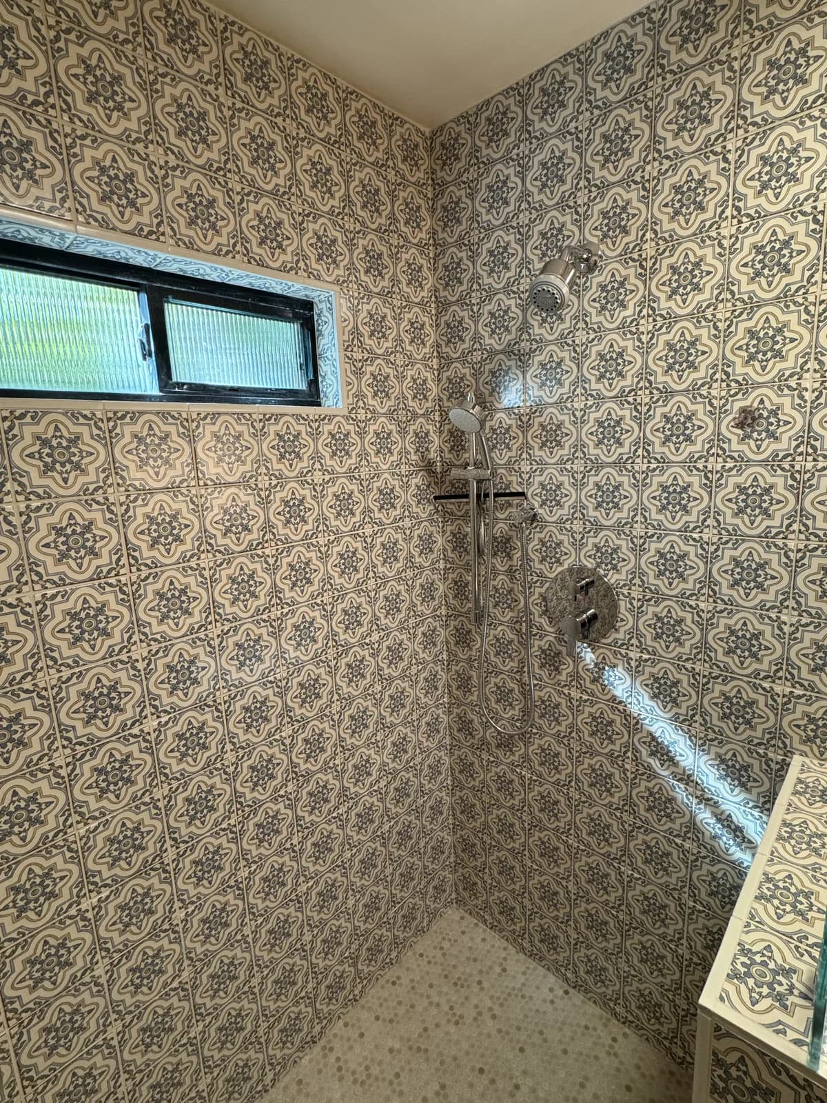 After: Looking up at the ceiling of the Arden shower — vintage Moroccan tile continues across the ceiling