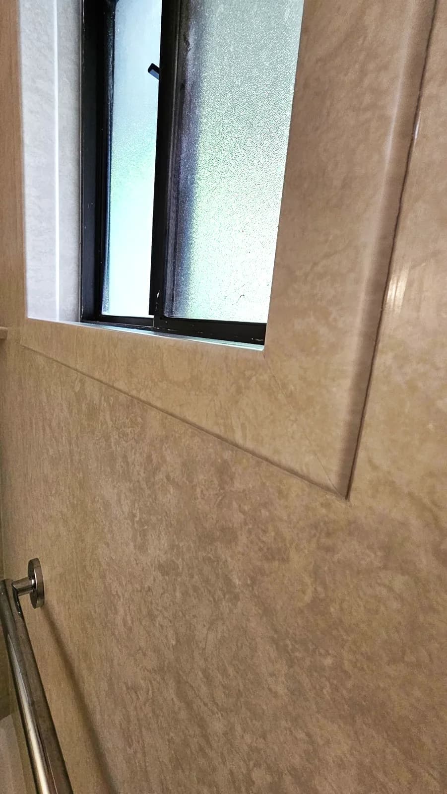 After: window opening sealed with an acrylic trim return above a chrome grab bar in Auburn, CA