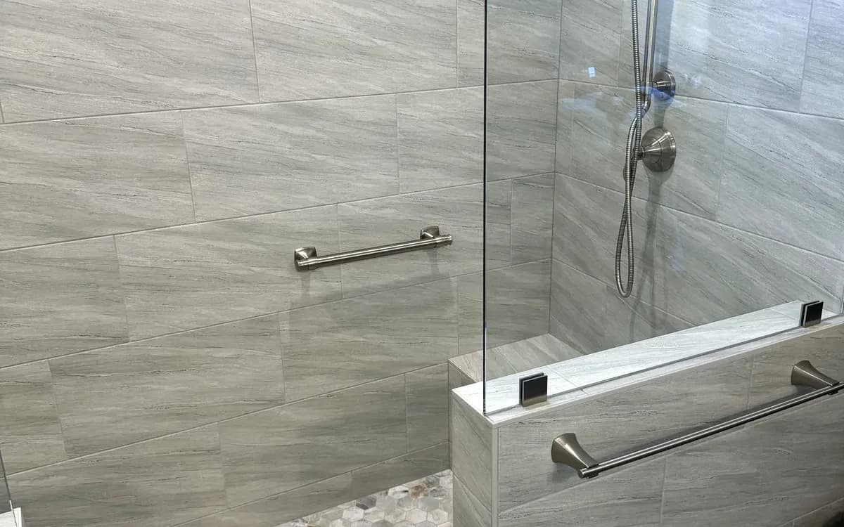 Tiled bench under the shower window with grab bar
