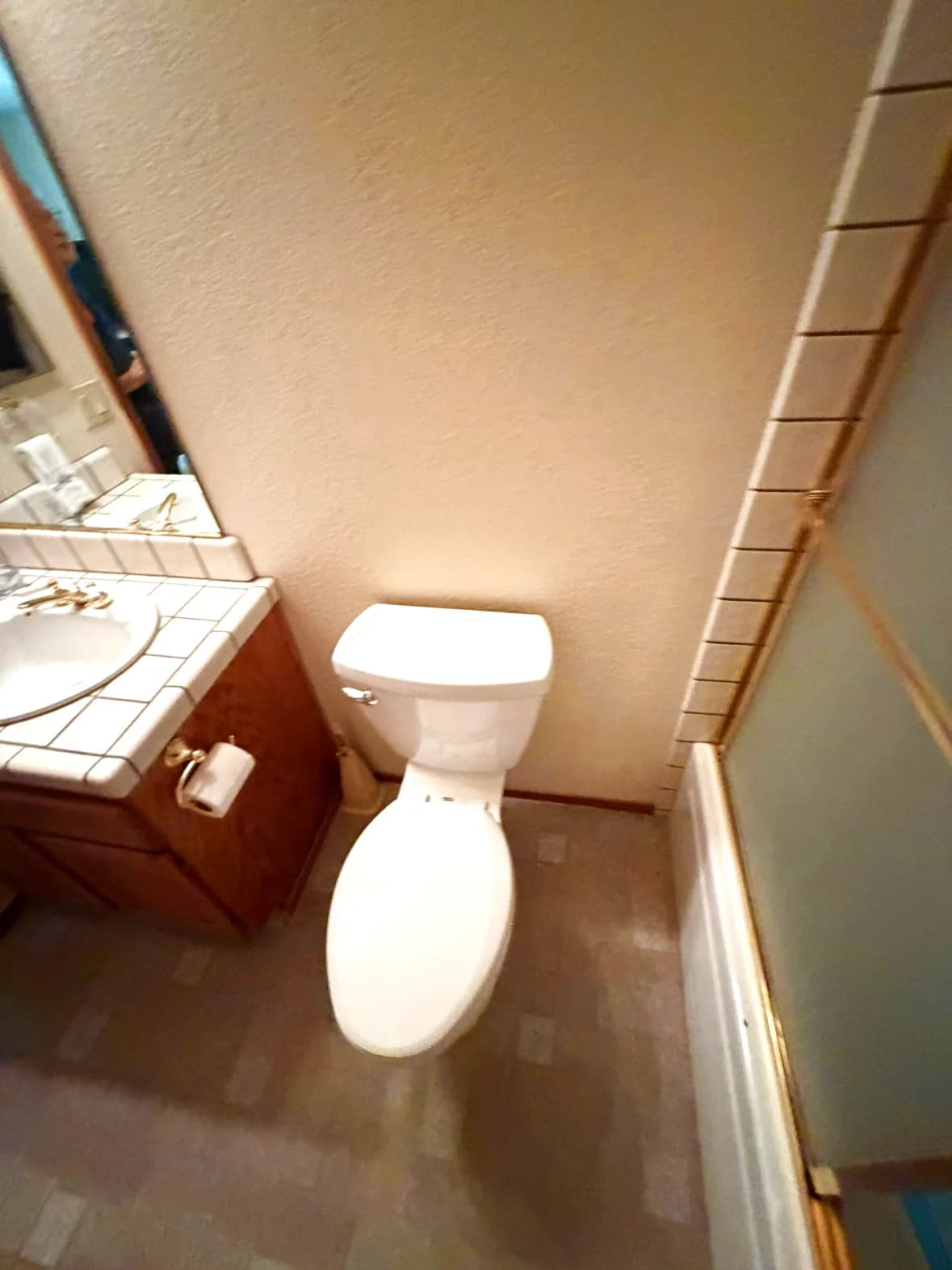 Before: Orangevale bathroom with cultured marble vanity, tile backsplash and toilet