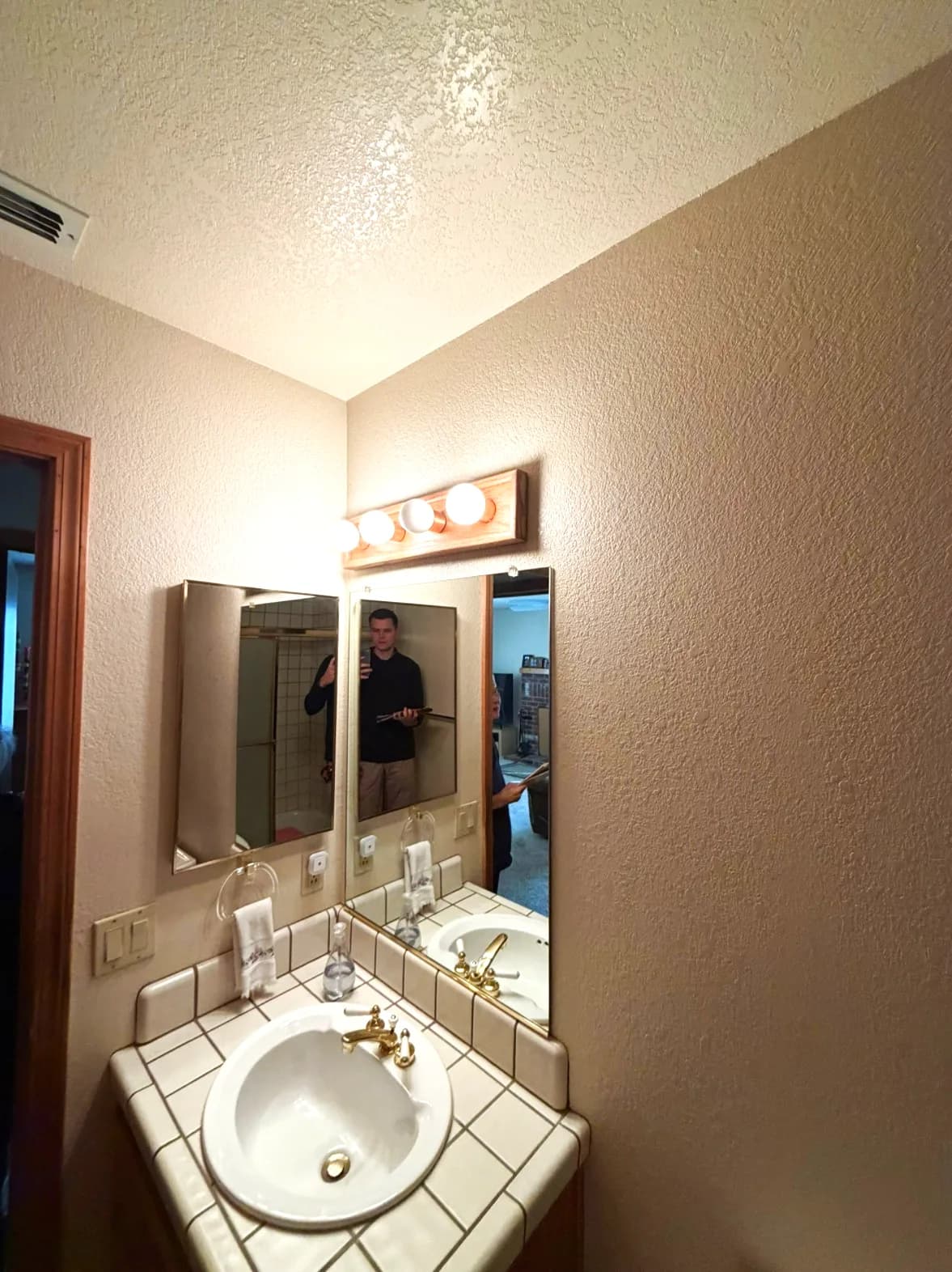 Before: Hollywood light bar over the vanity mirror