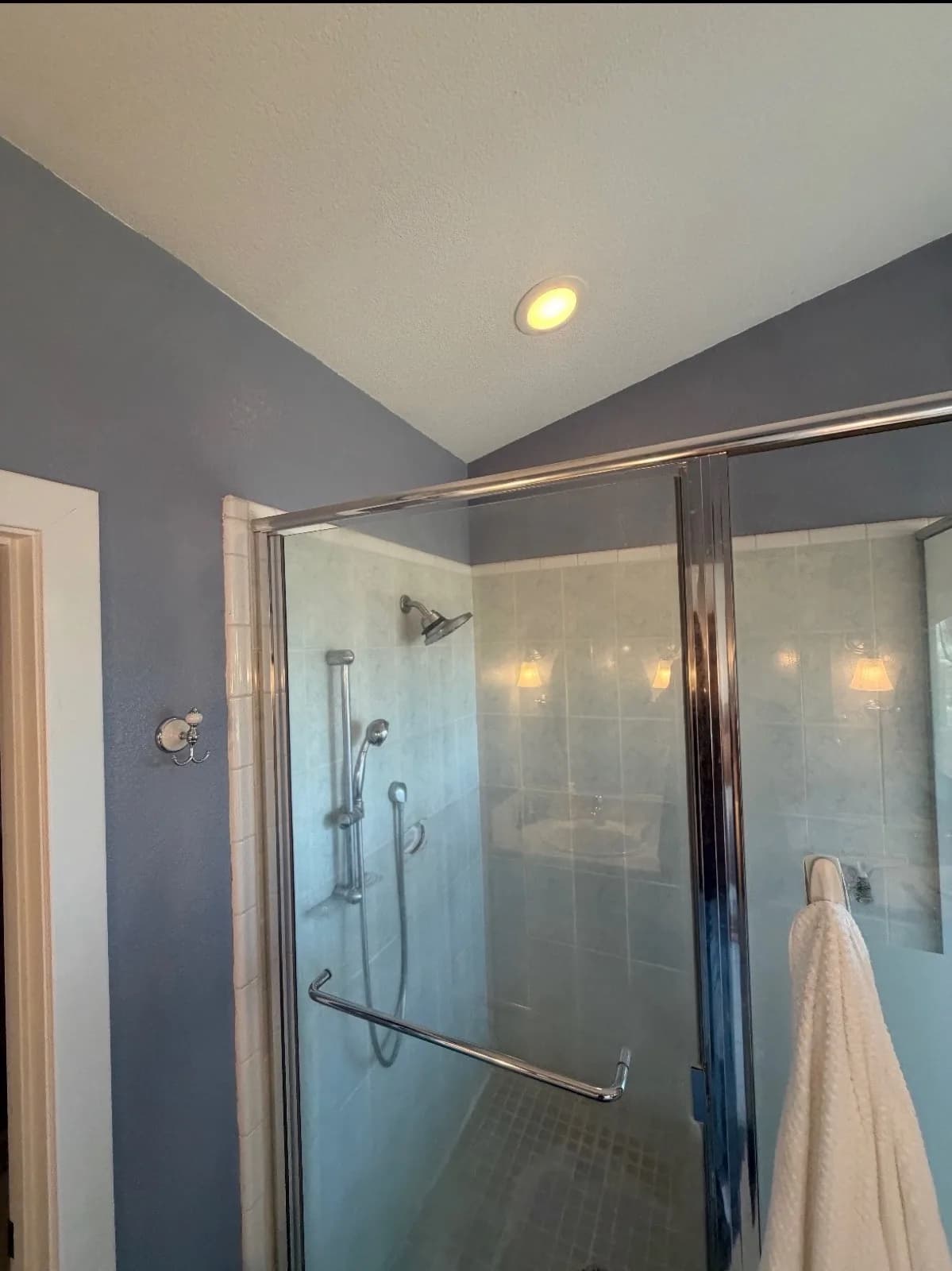Before: Pilot Hill master bathroom with framed sliding glass shower door and dated 4x4 white tile, lavender-grey walls