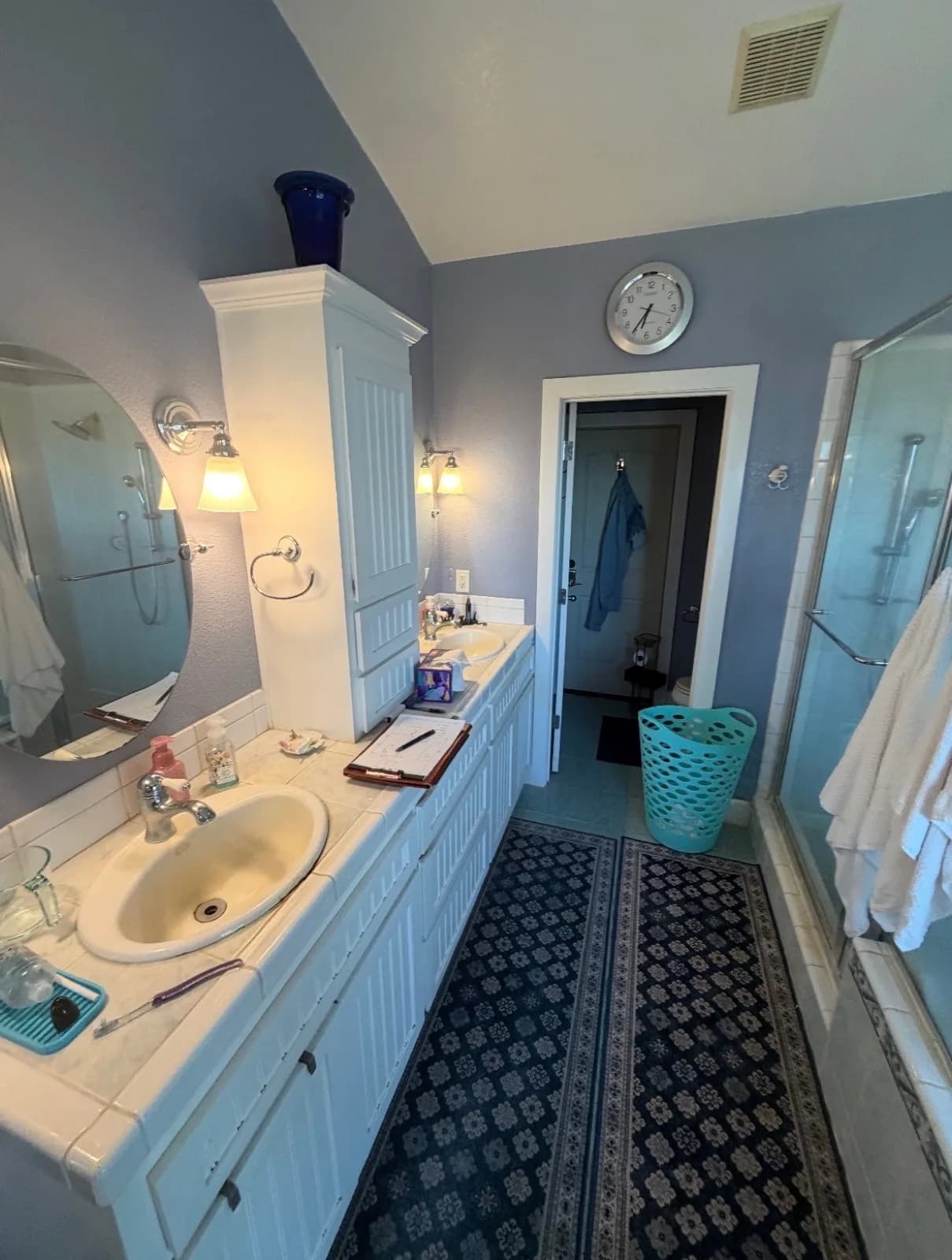 Before: Pilot Hill master bathroom with tub on the left, sliding glass shower door on the right, lavender-grey walls throughout