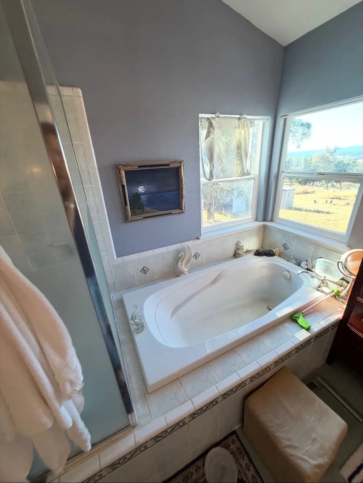Before: Pilot Hill master bathroom vanity detail — cultured marble countertop with double drop-in sinks and beadboard cabinets