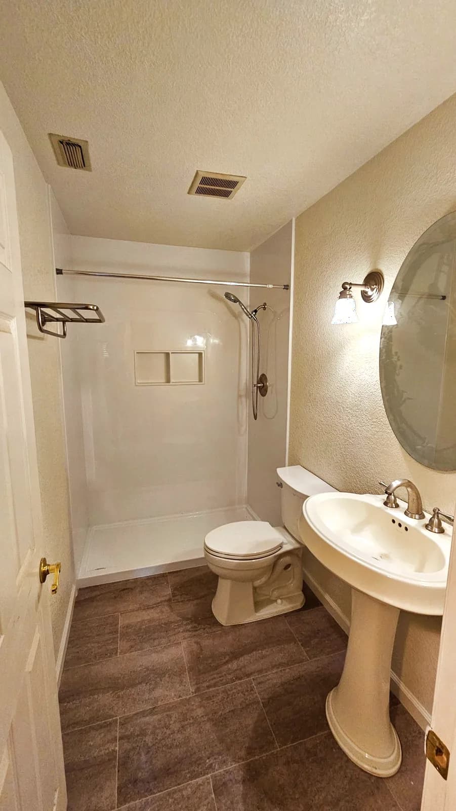 After: Woodland hallway bathroom with white acrylic shower walls, twin niche, vinyl plank floor and fresh paint